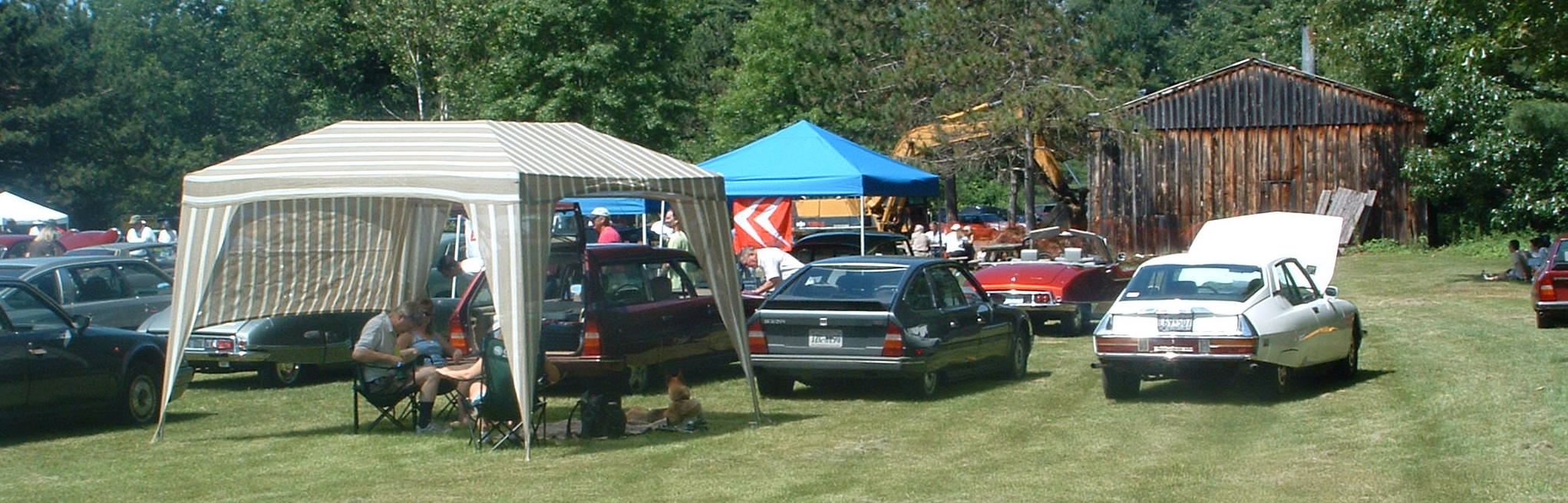 Three of our Citrons
		at Rendezvous 2007, held in Saratoga Springs, New York.  From left, the maroon CX is the 1987 Safari, next is the 
		1987 CX 25 GTI, and that's Dad's white 1973 SM.