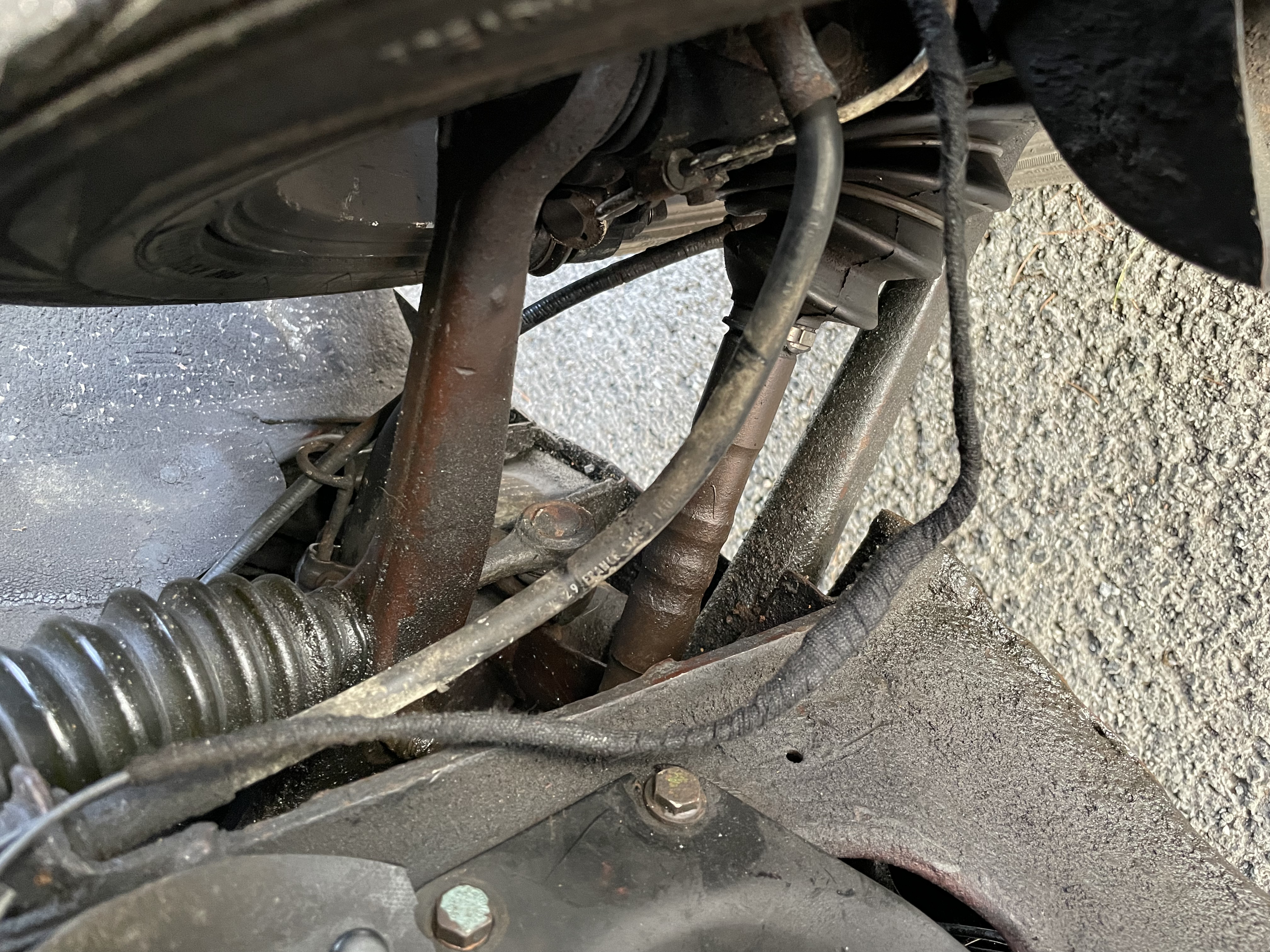 Finally, the wire is allowed to hang from caliper to subframe.  Do not be tempted to secure it, that only ends in failure.