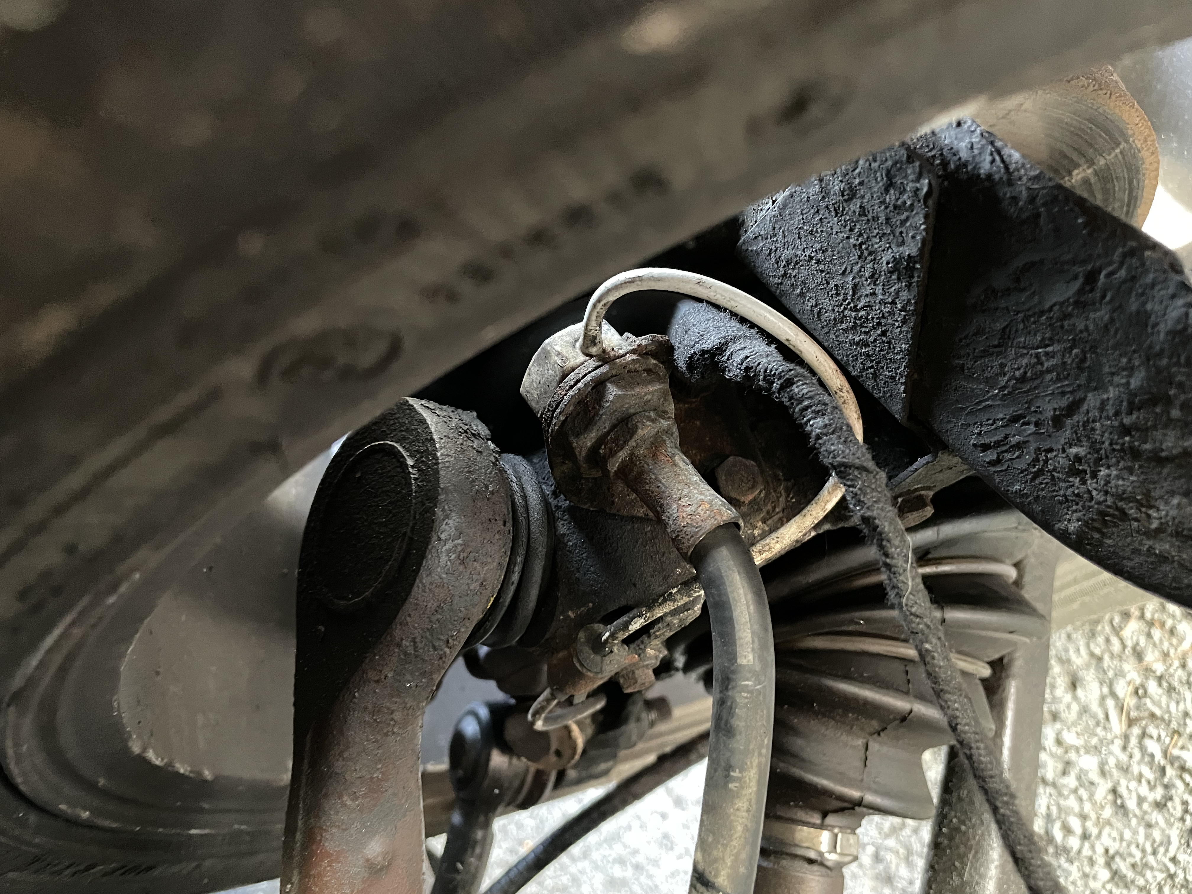 Wires exit the brake caliper without being secured.